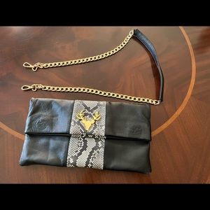 Taxidermy black leather clutch with python and gold accent